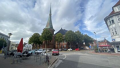Auf dem Bild ist die St. Bartholomäus-Kirche in Wilster und der Platz drumherum zu sehen.